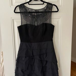BCBGMaxazria black cocktail dress with beaded/sequin/mesh detail on chest.
